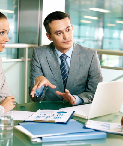 Group of business partners interacting at meeting in office